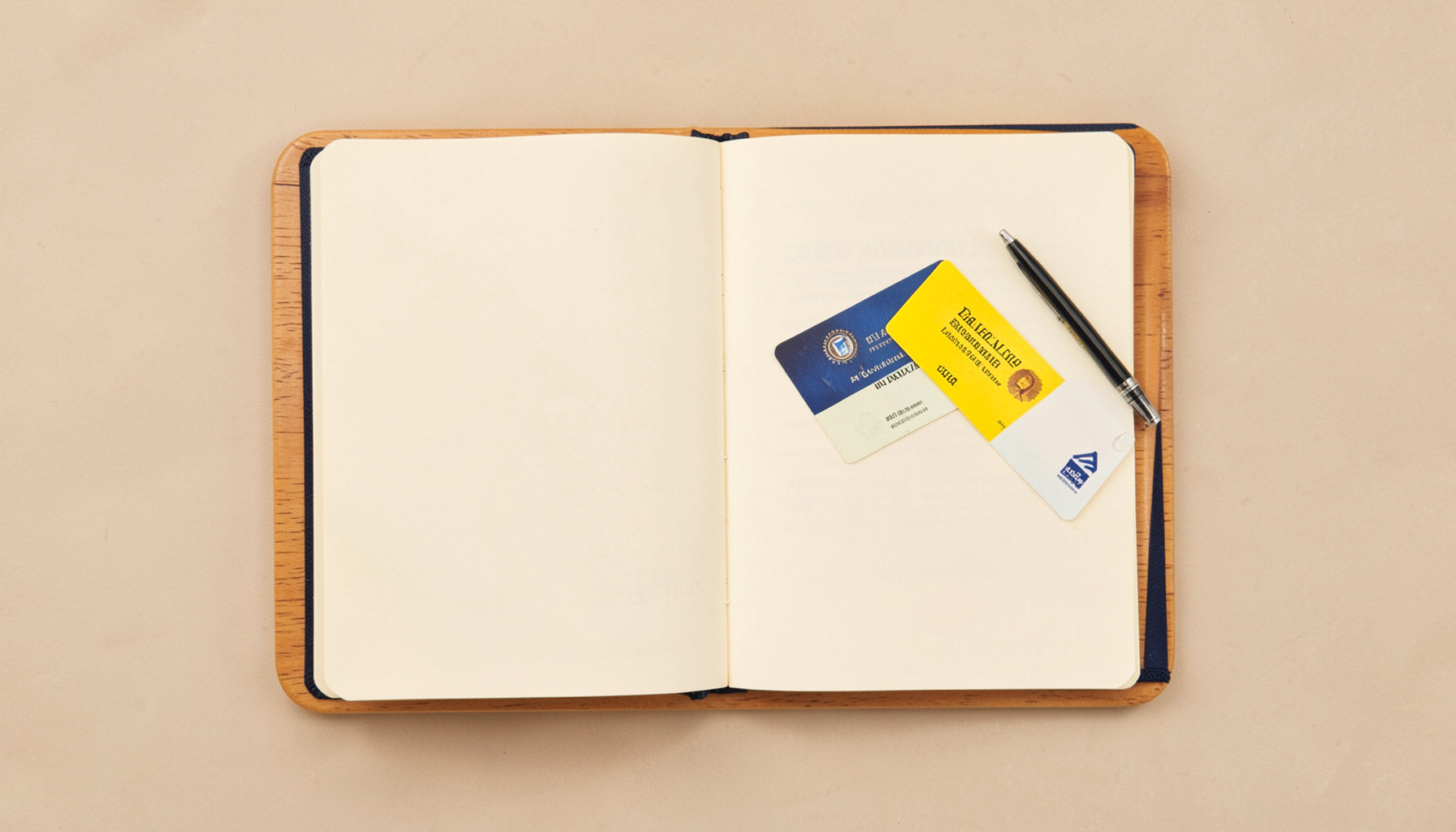 Overhead flat-lay photograph of a simple wooden desk with an open notebook, a pen, and a government exam admit card, bathed in warm natural light with soft cream and navy tones.